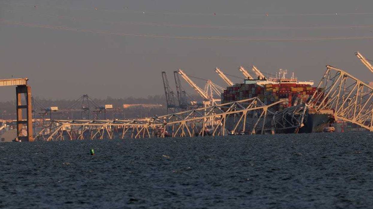 A cargo ship is shown after running into and collapsing the Francis Scott Key Bridge on March 26, 2024 in Baltimore, Maryland. Rescuers are searching for at least seven people, authorities say, while two others have been pulled from the Patapsco River.