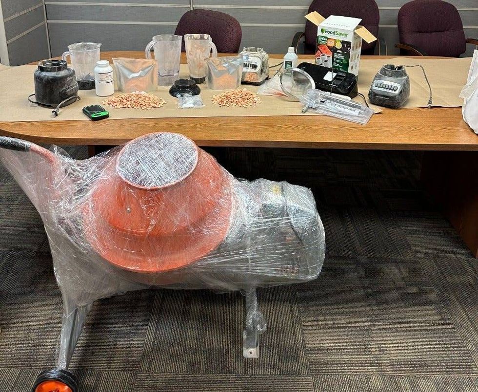 A cement mixed, pill and other items seized from a Sterling Heights home are displayed by Warren Police.