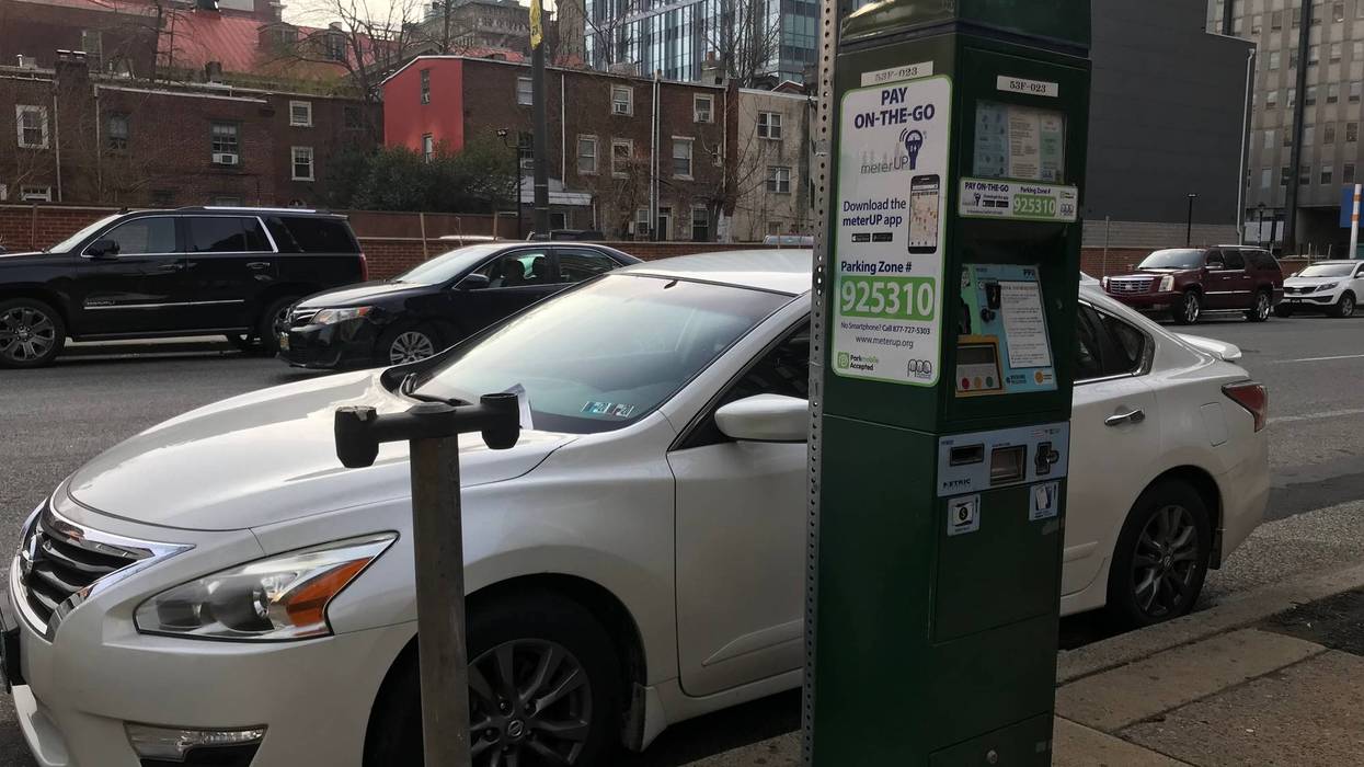 A Center City parking kiosk next to the remains of an old meter stand.
