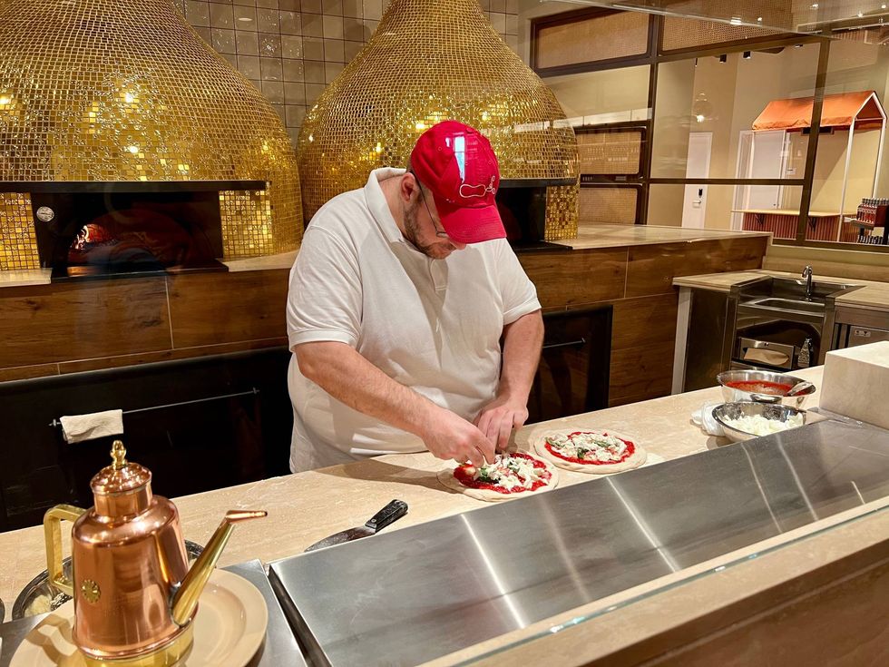 A chef making pizza at Eataly.