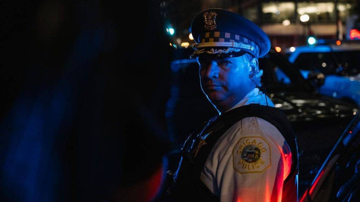 A Chicago Police Officer standing in evening shadows