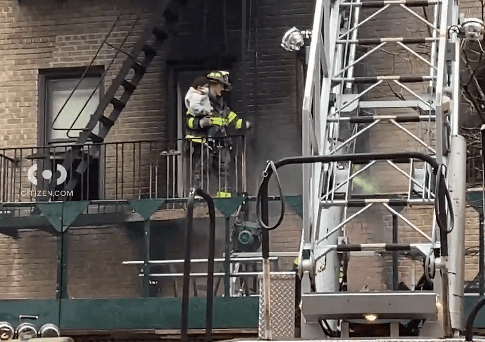 A child was carried to safety by a member of the FDNY, video shows
