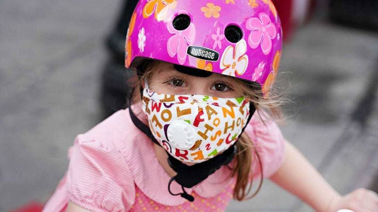 A child wearing a protective mask waits outside Lenox Hill Hospital to show gratitude to the medical staff during the coronavirus pandemic on May 15, 2020 in New York City.