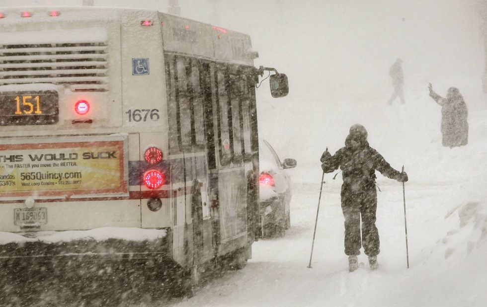 A city bus passes a skier on Michigan Avenue during a snowstorm February 2, 2011 in Chicago, Illinois. A blizzard dumped more than 20 inches of snow overnight in Chicago, making it the third largest snowfall recorded in the city