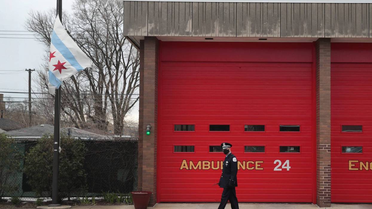A city of Chicago flag flies at half mast outside of a firehouse near the Taylor Funeral Home where a service was being held for Firefighter Edward Singleton, a 33 year veteran of the Chicago Fire Department, on April 22, 2020 in Chicago, Illinois.