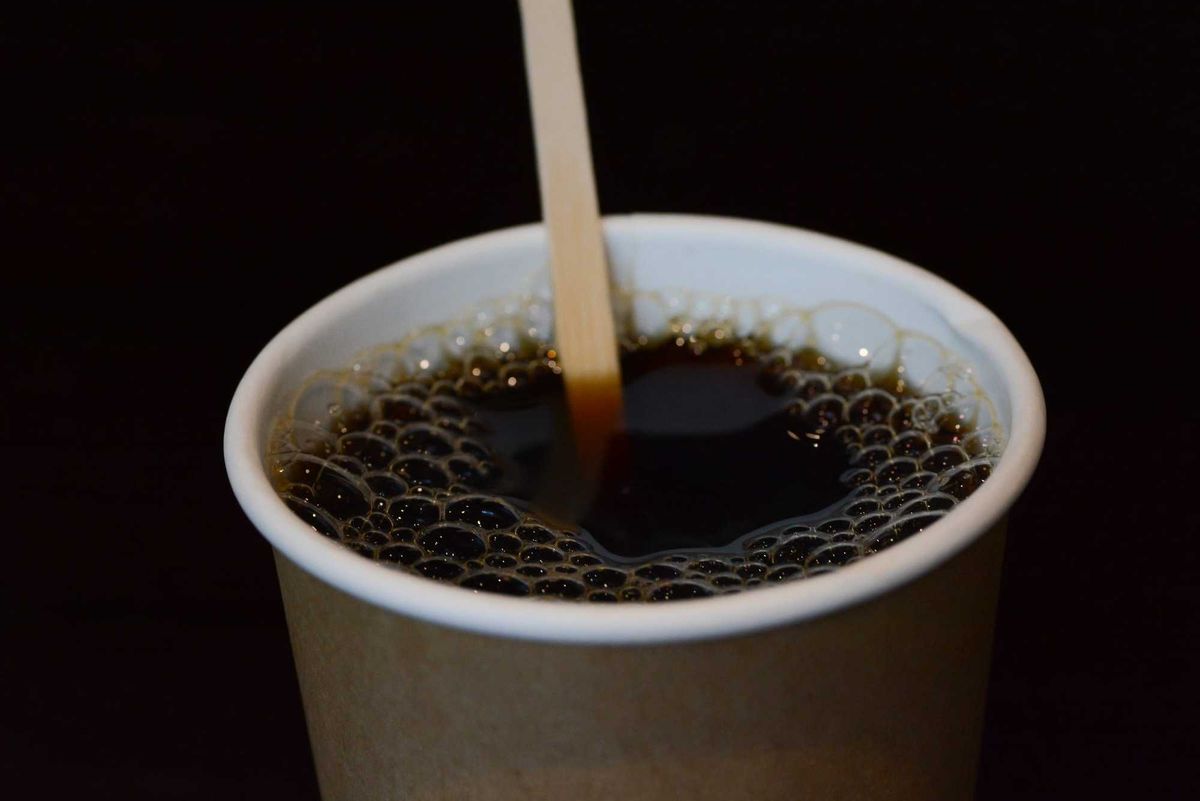 A close-up of a delicious cup of hot coffee enjoyed during the morning breakfast.