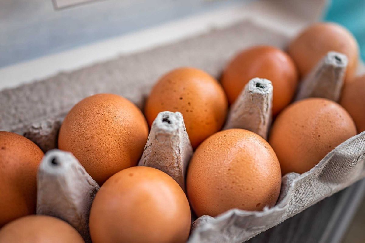 A close up of eggs in a carton.