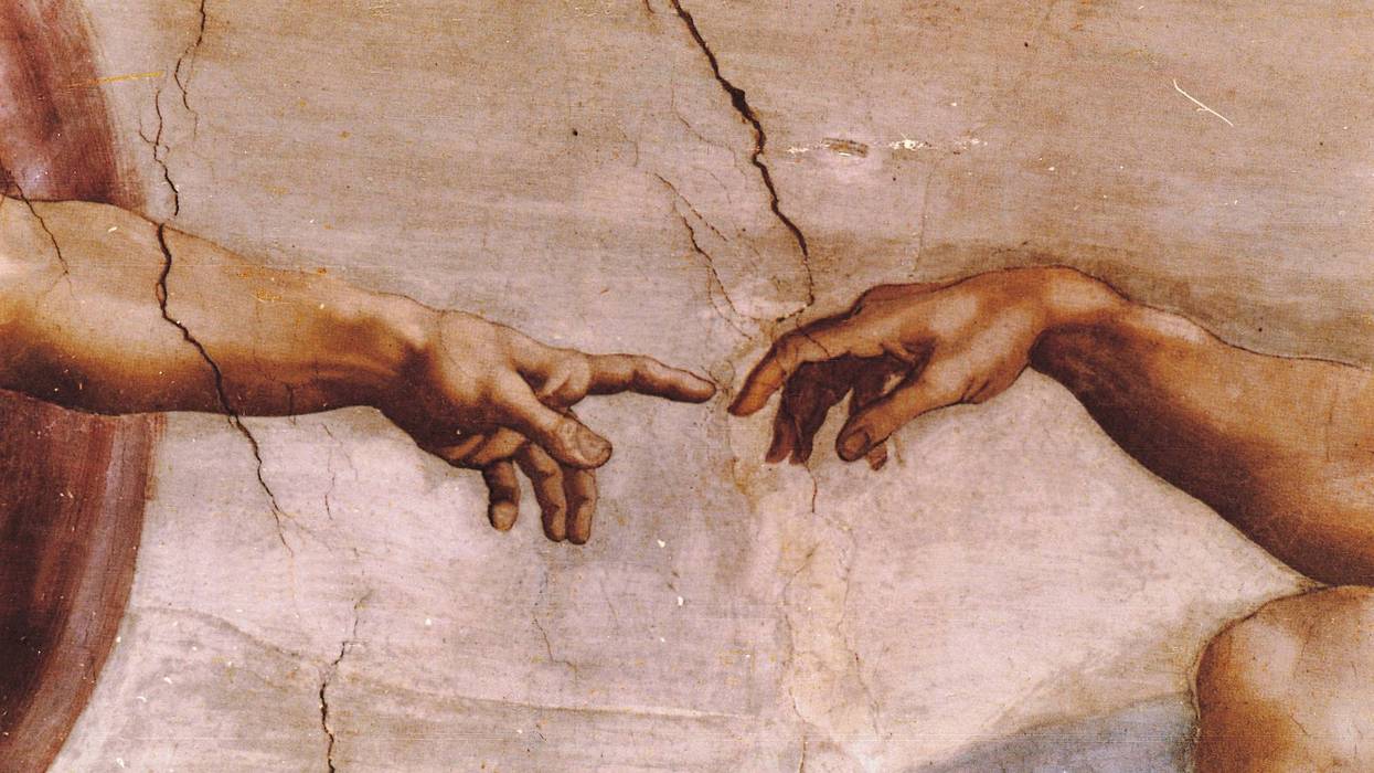 A close up of Michelangelo's Sistine Chapel fesco painting "Creation of Adam".