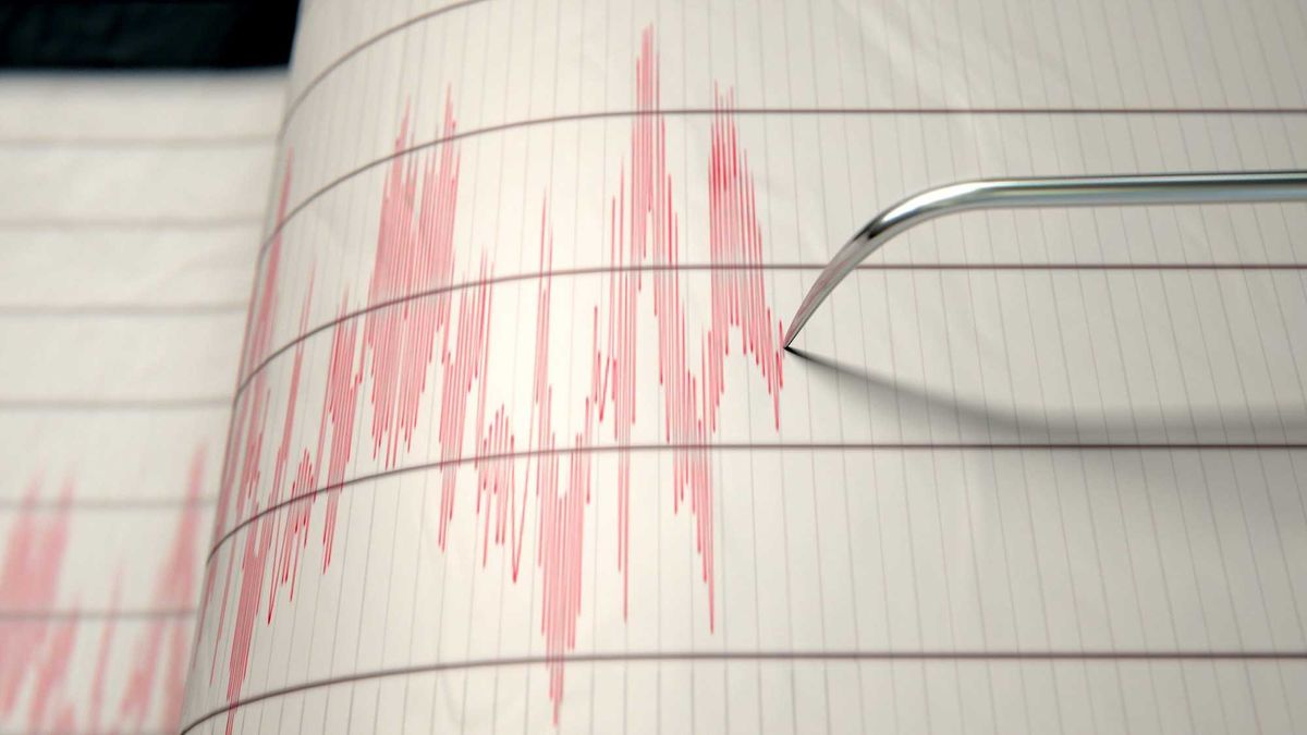 A closeup of a seismograph machine needle drawing a red line on graph paper depicting seismic and eartquake activity - 3D render