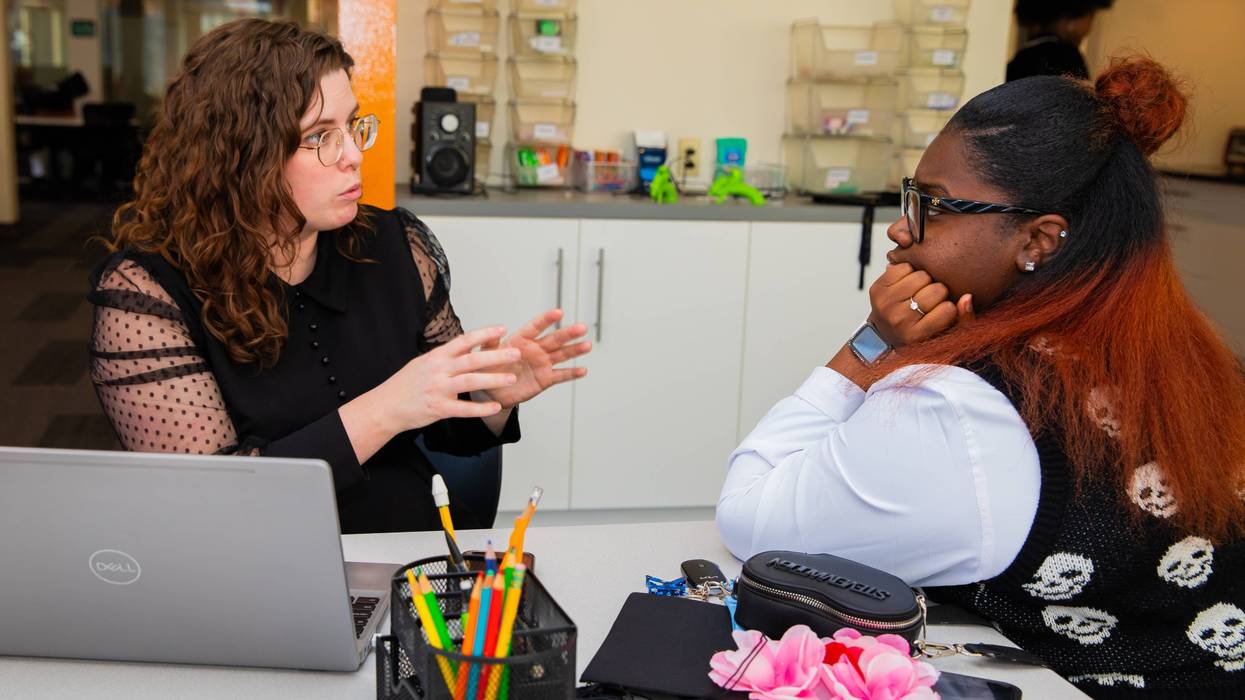 A college counselor speaks with a Gen Z student.