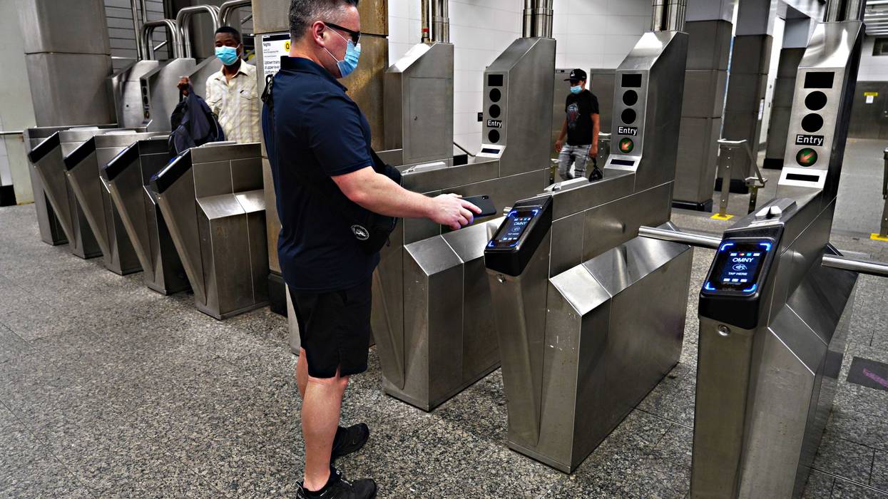 A commuter uses the OMNY tap-to-pay system.