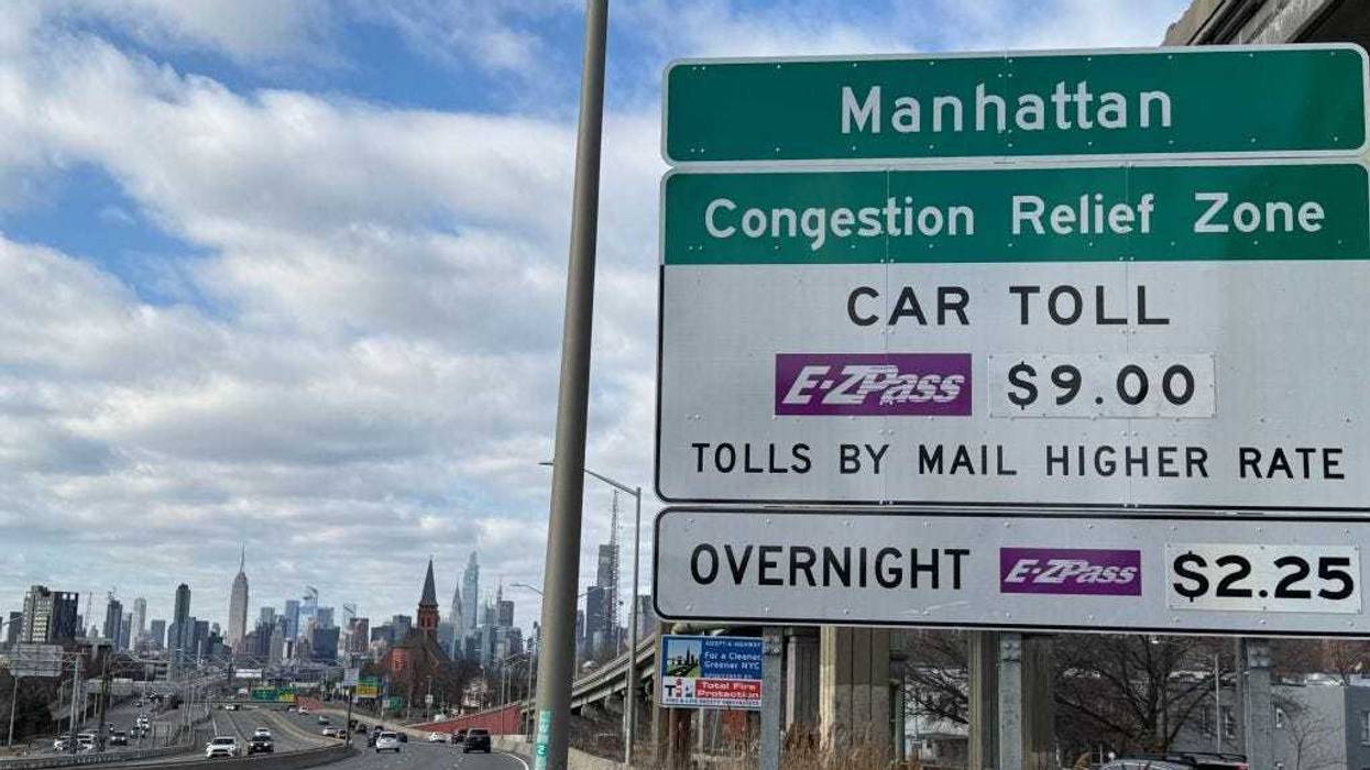 A congestion pricing car toll sign on the westbound Long Island Expressway approaching Van Dam Street in Queens, New York.