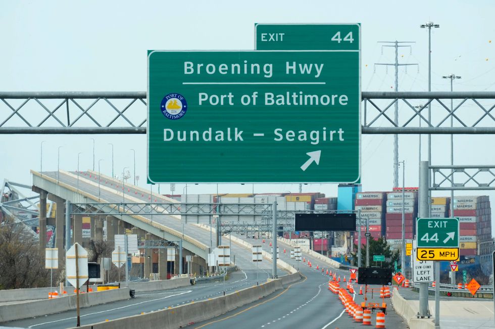 A container ship as it rests against the wreckage of the Francis Scott Key Bridge on March 26, 2024, as seen from Dundalk, Md. The ship rammed into the major bridge in Baltimore early Tuesday, causing it to collapse in a matter of seconds and creating a terrifying scene as several vehicles plunged into the chilly river below.