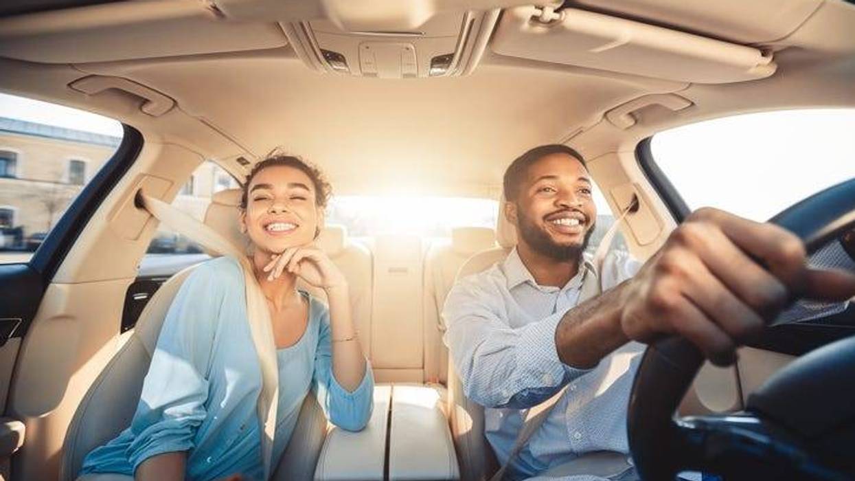 A couple in the car smiling and happy