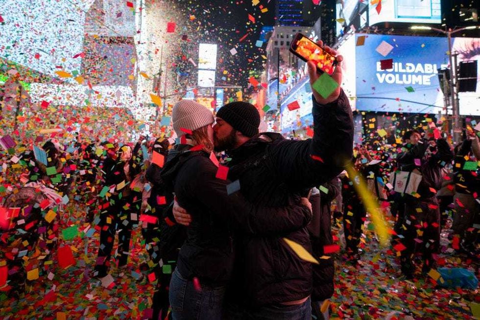 A couple kisses as the clock strikes midnight in Times Square during New Year celebrations on Jan. 1, 2025 in New York City.