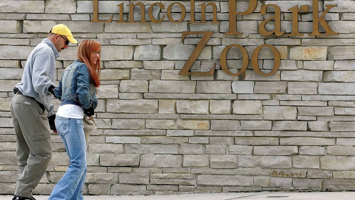 A couple skates toward an entrance to Lincoln Park Zoo May 16, 2005 in Chicago, Illinois.