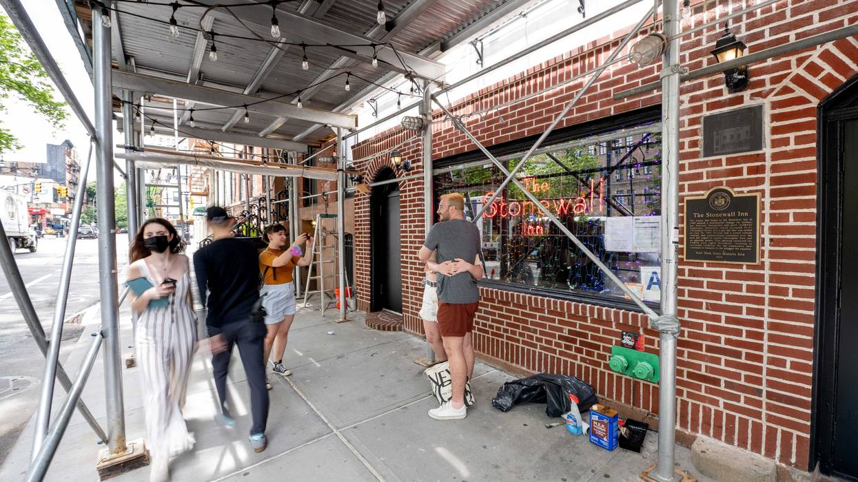 A couple takes a photo in front of the Stonewall Inn on June 02, 2021 in New York City. The Stonewall Inn was the site of the 1969 Stonewall Riots which are considered the spark of the gay liberation movement and the contemporary LGBTQ movement in the United States.