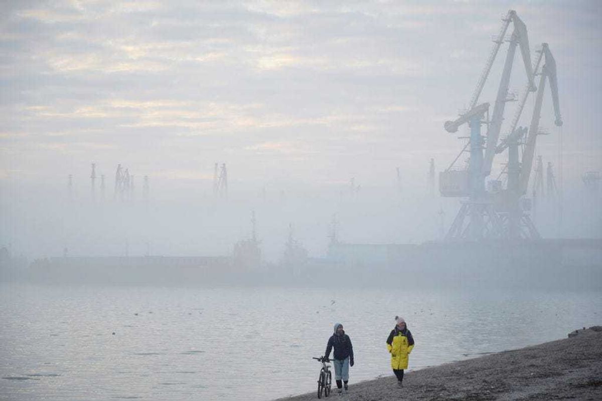 A couple walks on a beach near the port of Berdyansk on the Azov Sea on February 16, 2022 in Berdyansk, Ukraine.(Photo by Pierre Crom/Getty Images)