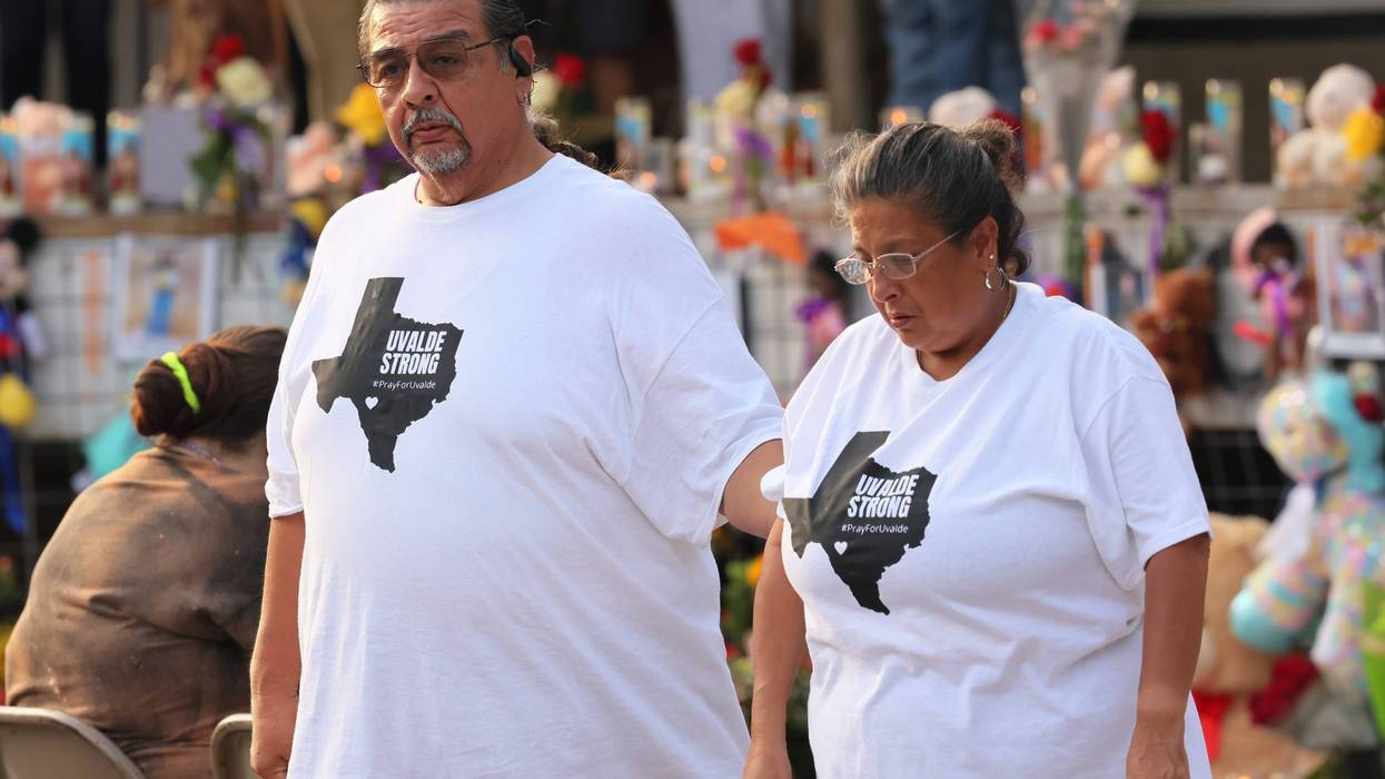 A couple wears "Uvalde Strong" t-shirts during a vigil for the victims of the Robb Elementary School mass shooting at Sacred Heart Catholic Church on May 28, 2022 in Uvalde, Texas.