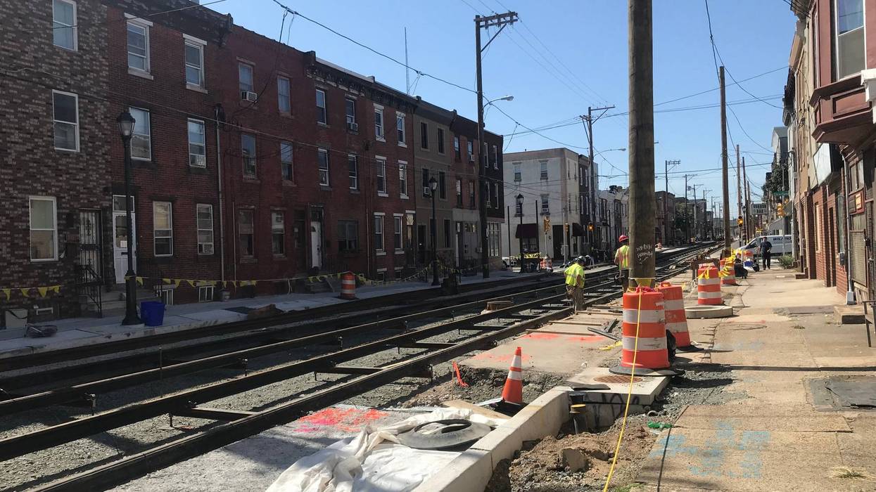 A crew working to install trolley tracks along Richmond St.