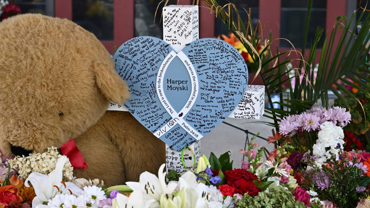 A cross with the name of 10-year-old shooting victim Harper Moyski is seen amid flowers at Annunciation Catholic Church on September 3, 2025 in Minneapolis, Minnesota. The shooting left two students dead and many more wounded.