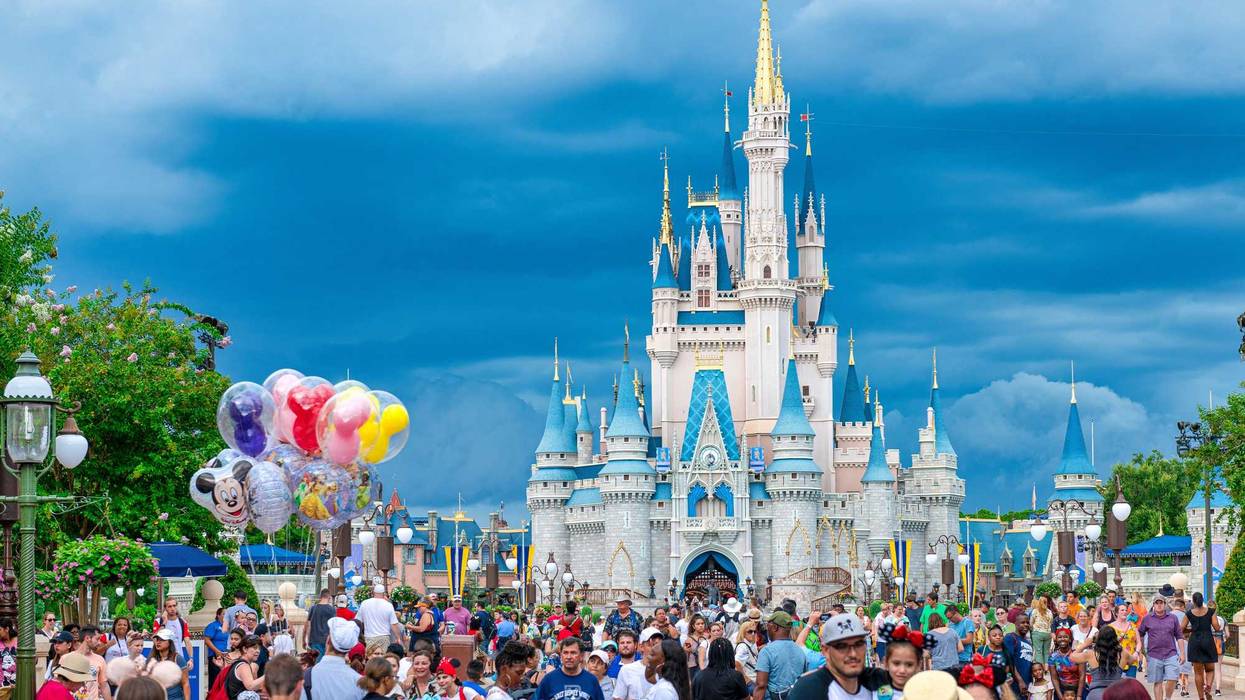 A crowd of people is seen at the Cinderella Castle in Walt Disney World