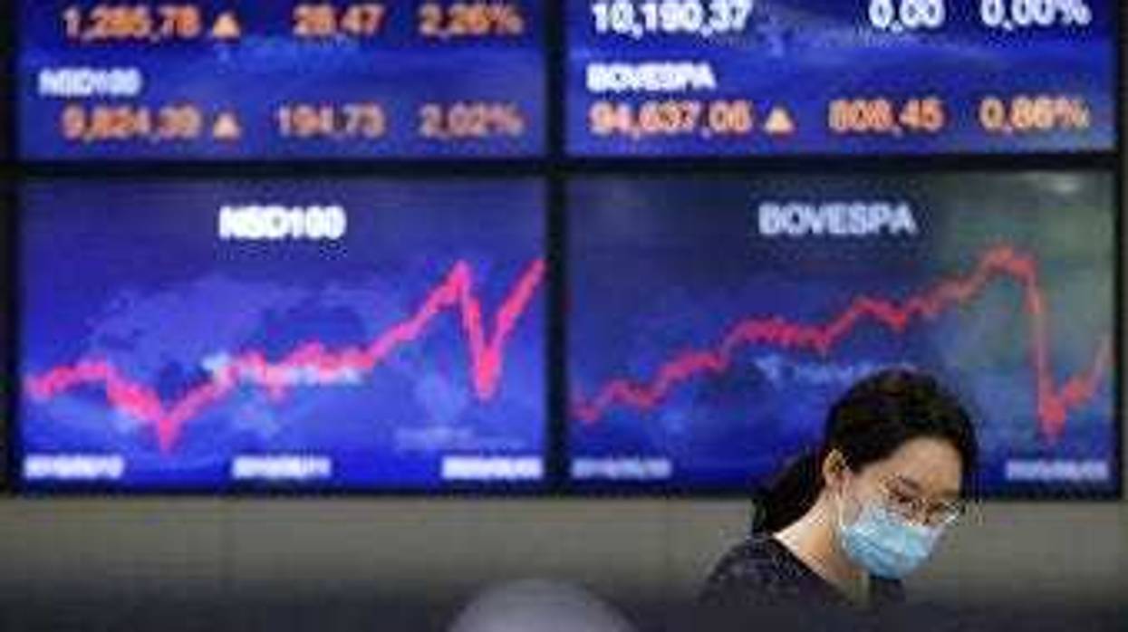 A currency trader watches monitors at the foreign exchange dealing room of the KEB Hana Bank headquarters in Seoul, South Korea, Monday, June 8, 2020. (AP Photo/Ahn Young-joon)