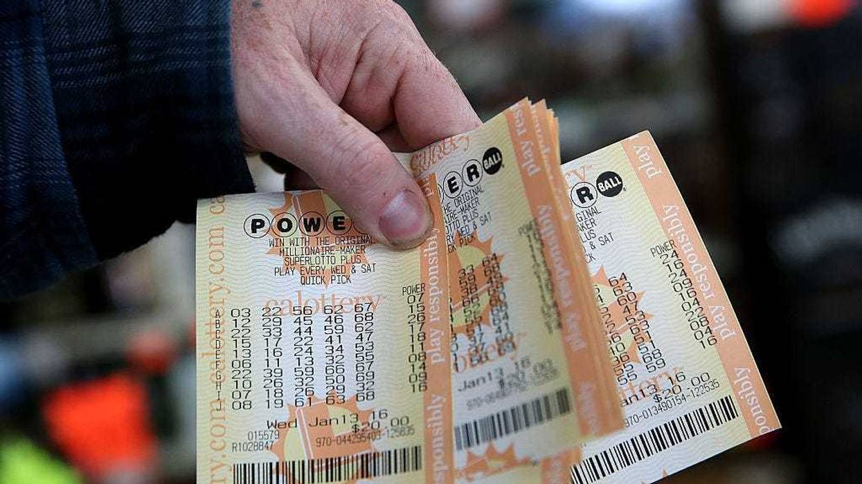 A customer holds a handful of Powerball tickets at Kavanagh Liquors on January 13, 2016 in San Lorenzo, California.