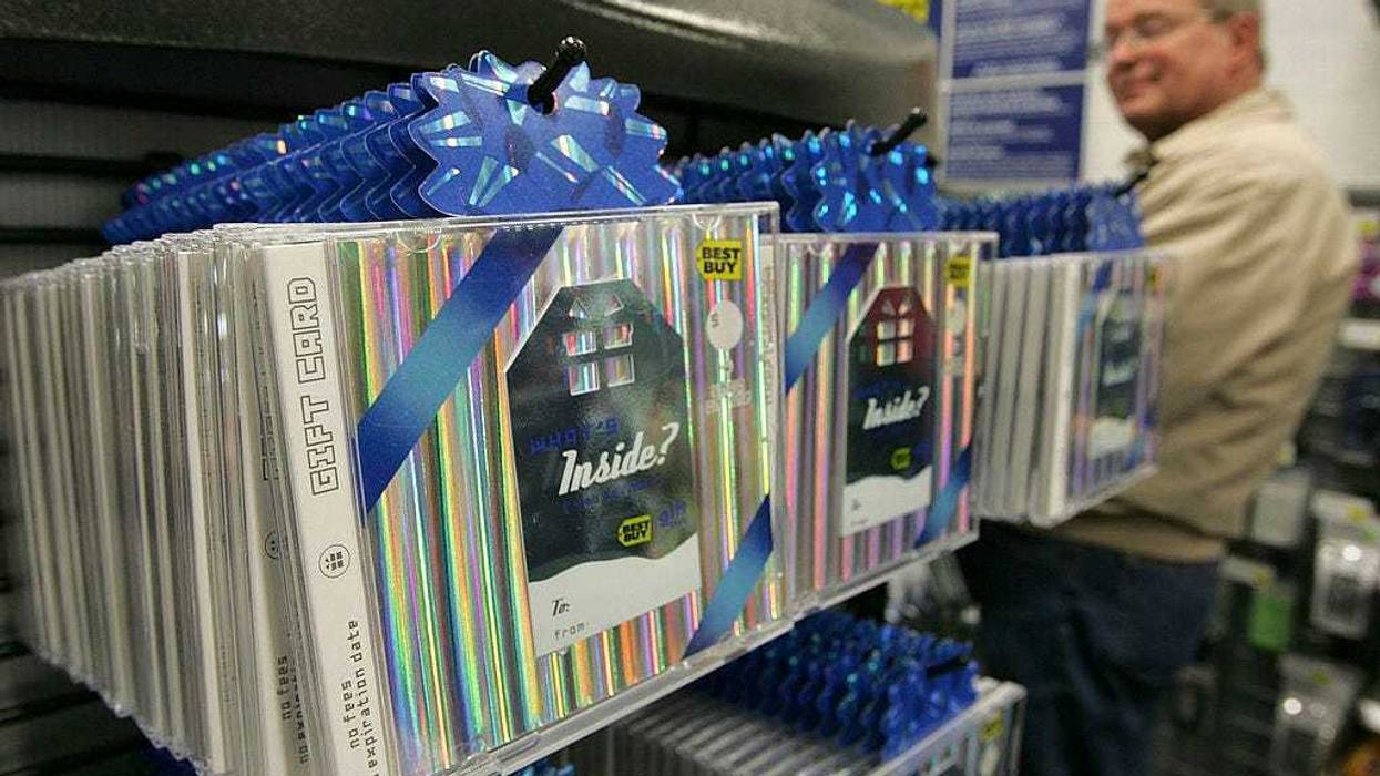 A customer looks at a display of Best Buy gift cards at a Best Buy store December 29, 2005 in San Francisco, California. Retailers experience a rise in gift card sales this holiday season and hope that customers will redeem them during post holiday sales since gift cards do not register as a sale until they are redeemed. (Photo by Justin Sullivan/Getty Images)