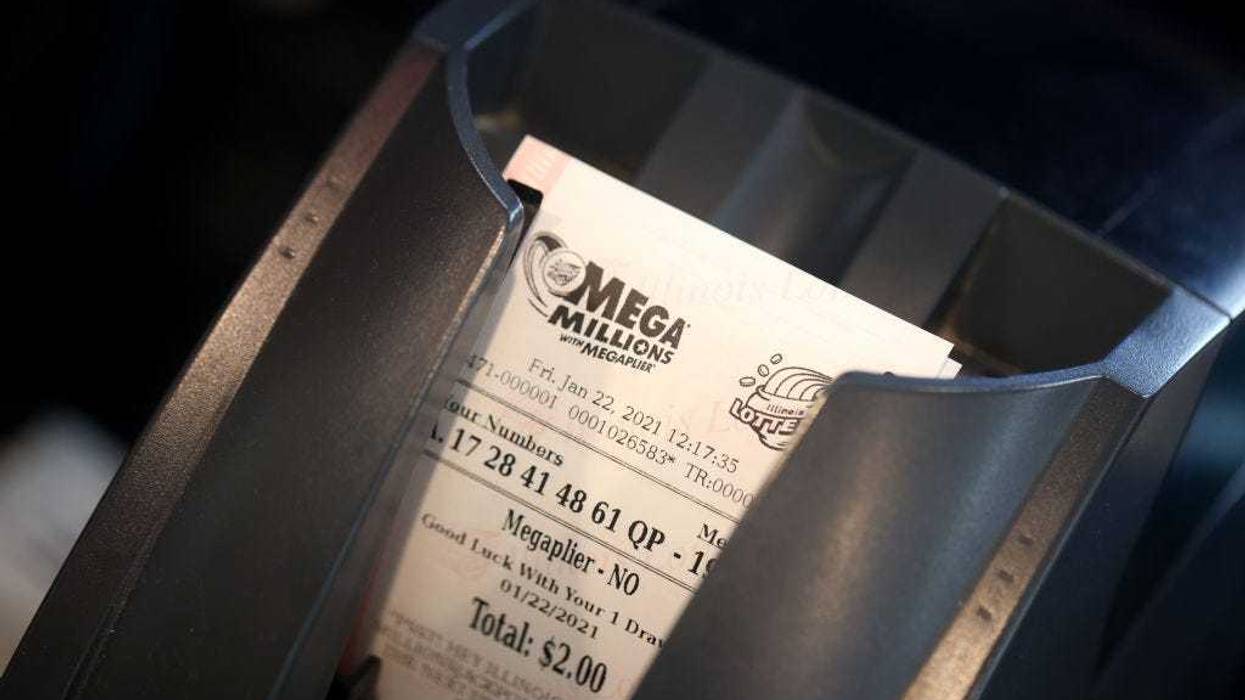 A customer purchases a Mega Millions lottery ticket.