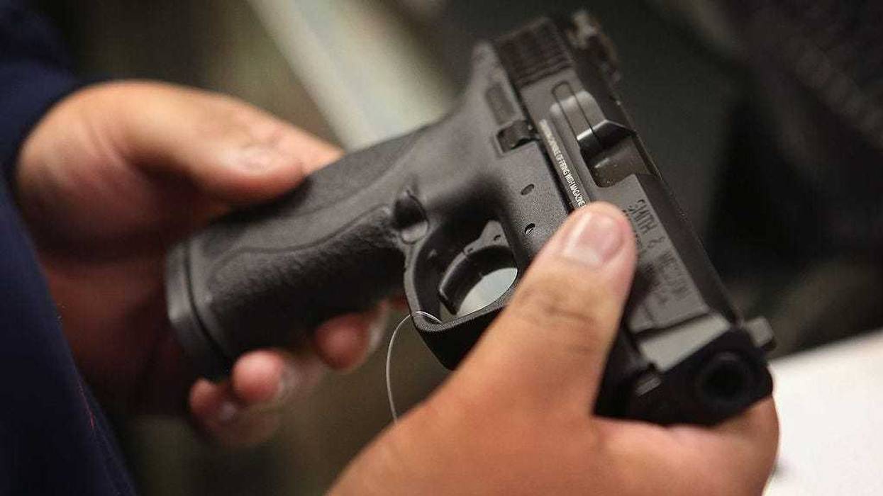 A customer shops for a pistol at Freddie Bear Sports sporting goods store on December 17, 2012 in Tinley Park, Illinois.