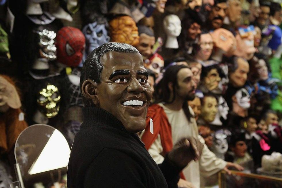 A customer tries on a Barack Obama Halloween mask at Fantasy Costumes on October 28, 2011 in Chicago, Illinois.