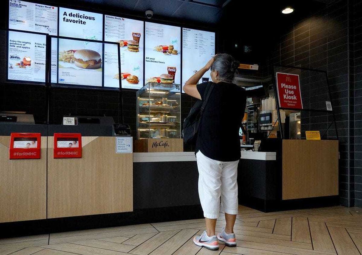 A customer waits to order food at a McDonalds fast food restaurant on July 26, 2022 in Miami, Florida. The McDonald's company reported U.S. same-store sales rose 3.7%, while international sales rose 9.7% during the most recent quarter.