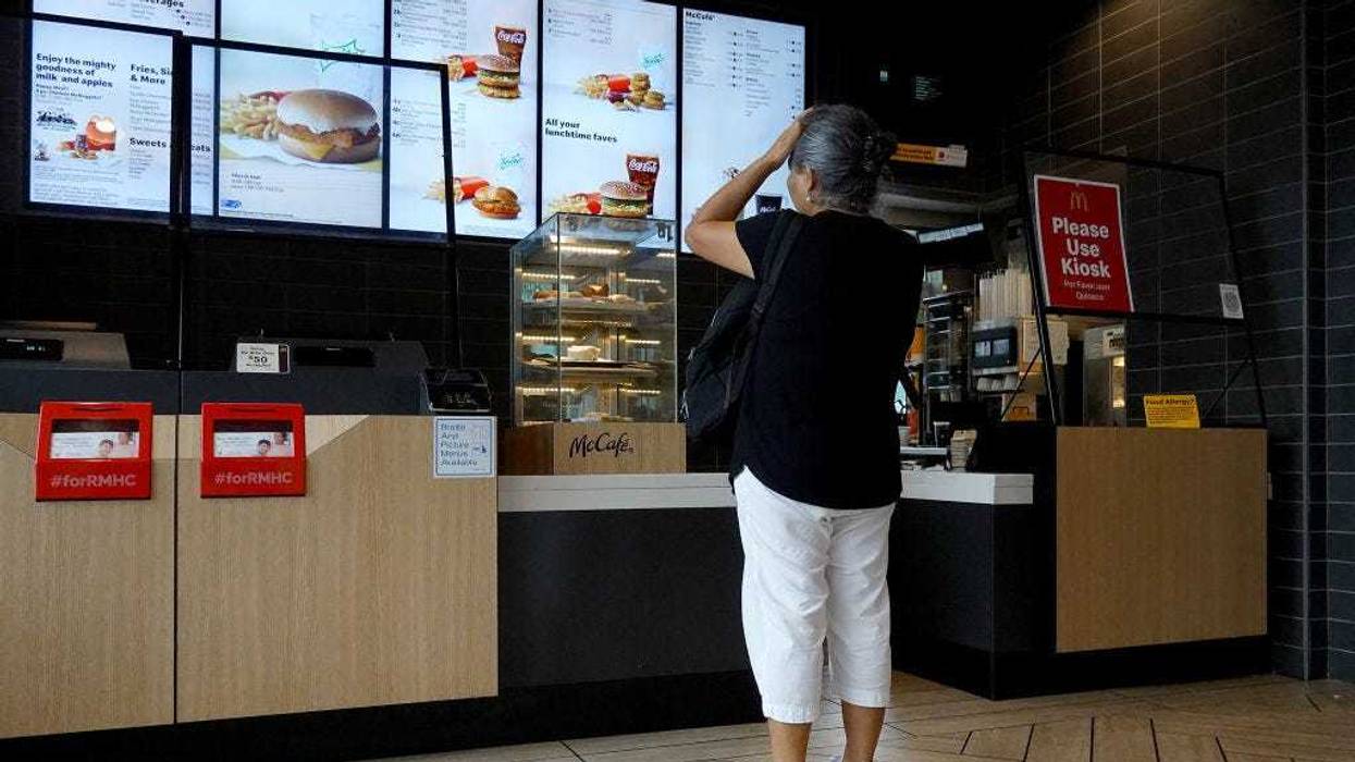 A customer waits to order food at a McDonalds fast food restaurant on July 26, 2022 in Miami, Florida. The McDonald's company reported U.S. same-store sales rose 3.7%, while international sales rose 9.7% during the most recent quarter.