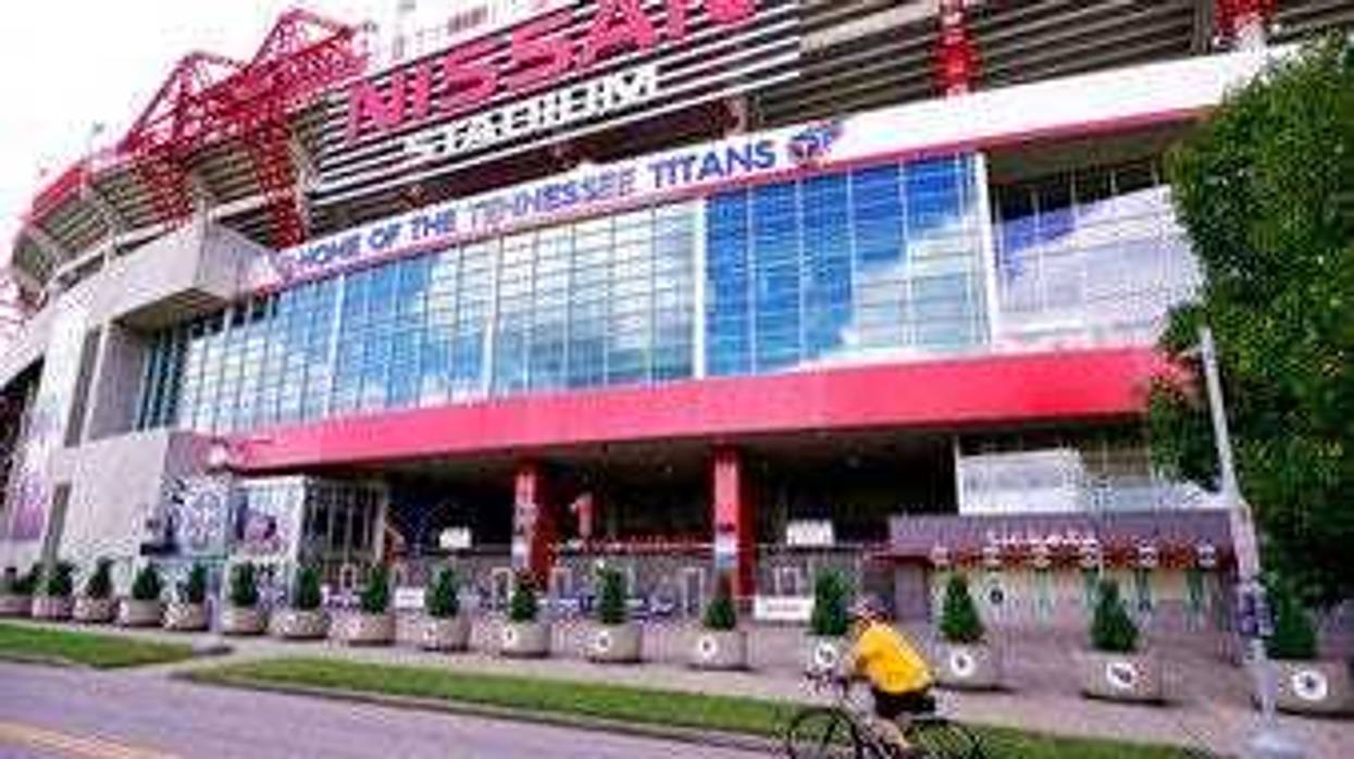 A cyclist passes by Nissan Stadium, home of the Tennessee Titans, Tuesday, Sept. 29, 2020, in Nashville, Tenn. (AP Photo/Mark Humphrey)