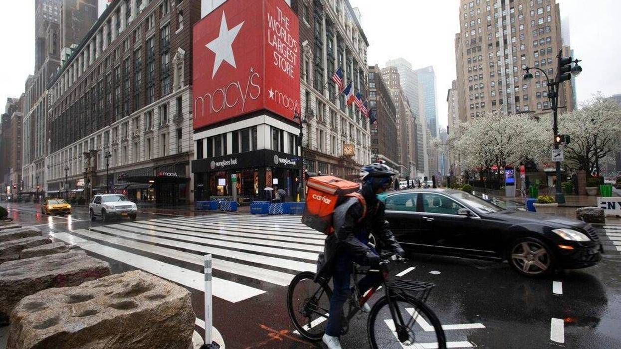 A cyclist passes Macy's in Herald Square, Monday, March 23, 2020, in New York. Macy's stores nationwide are closed due to the coronavirus.