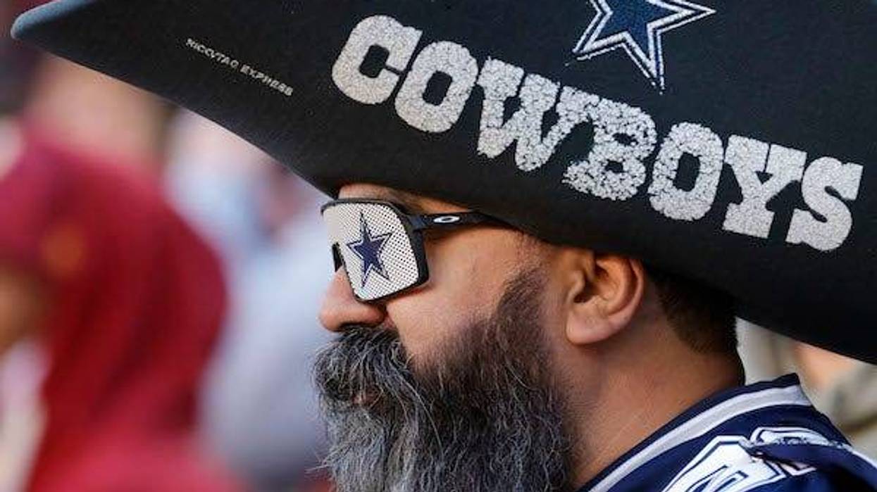 A Dallas Cowboys fan watches from the stands against the Washington Football Team
