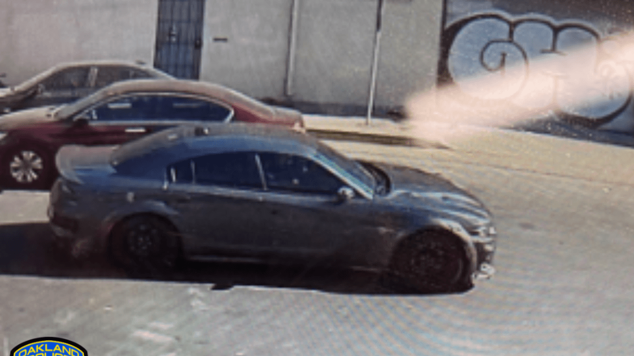 A dark gray Dodge Charger on an Oakland street.