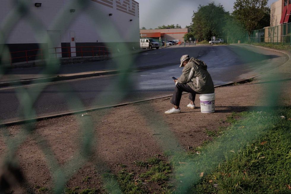 A day laborer waits for possible work near a Home Depot in the Bronx