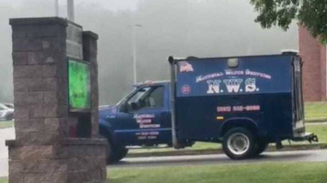 A dead body was found in a garbage truck outside a Long Island middle school on Thursday morning.