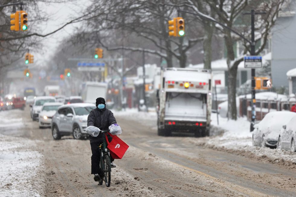 A delivery person rides their bike down Church Avenue in the Flatbush neighborhood of Brooklyn on December 16, 2020 in New York City.