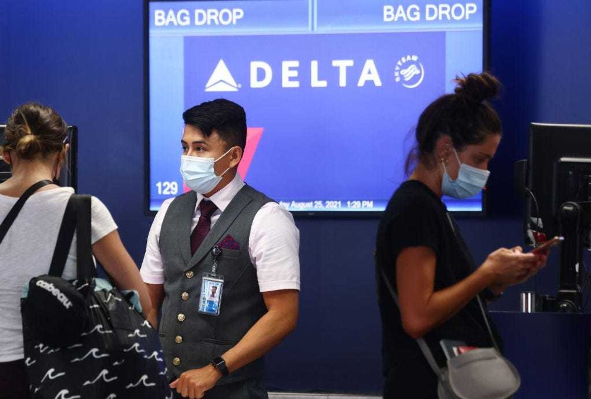 A Delta Air Lines employee works on the departures level at Los Angeles International Airport (LAX) on August 25, 2021 in Los Angeles, California.