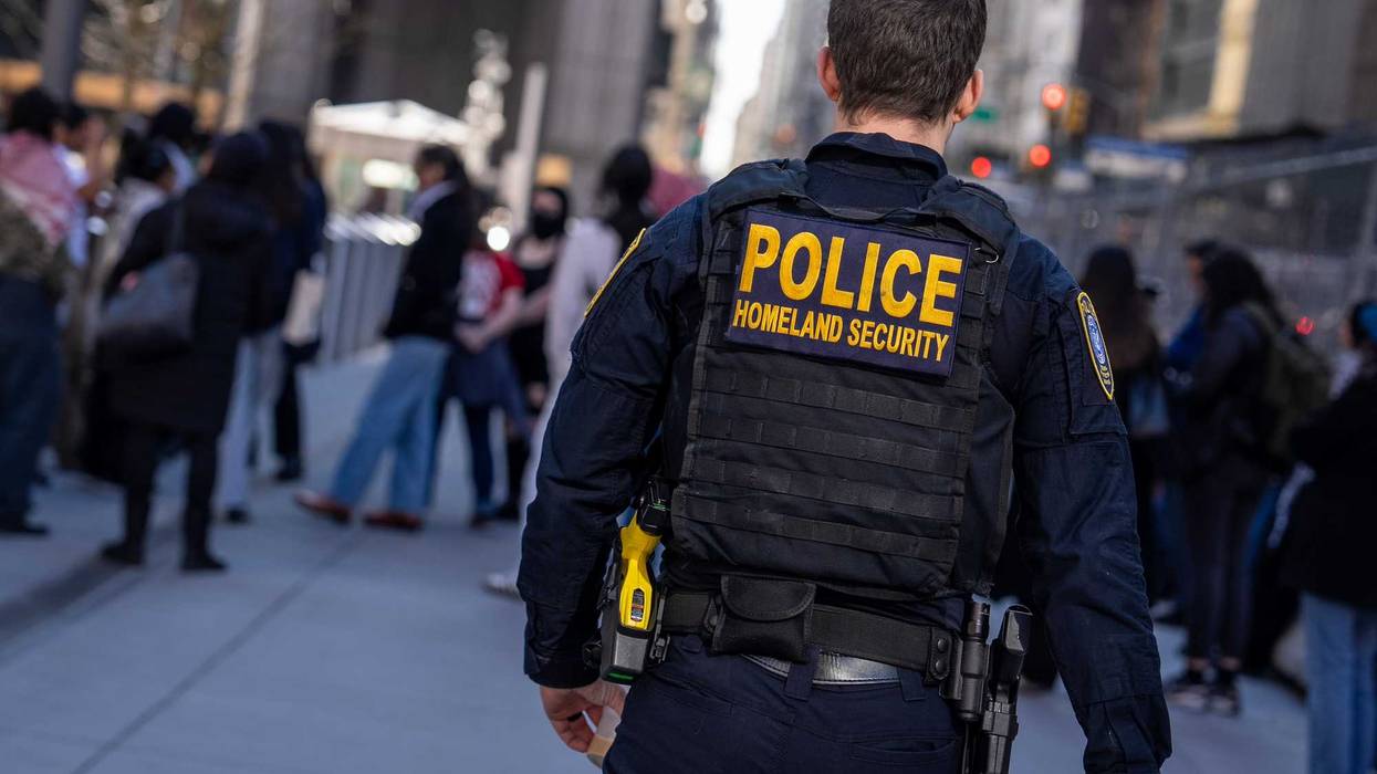 A Department of Homeland Security officer stands guard at 26 Federal Plaza as protesters gather to demand the release of Mahmoud Khalil at Foley Square on March 10, 2025