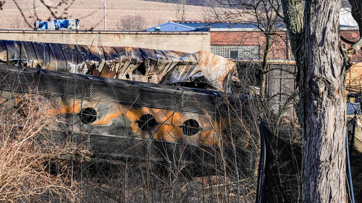 A derailed train car is seen from the backyard of home in East Palestine, Ohio. About 50 train cars,