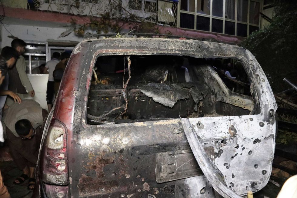 A destroyed vehicle is seen inside a house after a U.S. drone strike in Kabul, Afghanistan, Sunday, Aug. 29, 2021. A U.S. drone strike destroyed a vehicle carrying "multiple suicide bombers" from Afghanistan