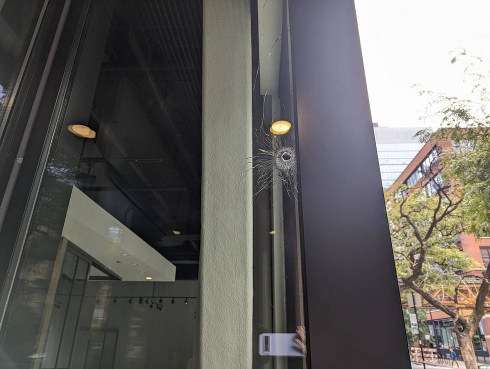 A detail shot shows a bullet hole in a pane of glass.