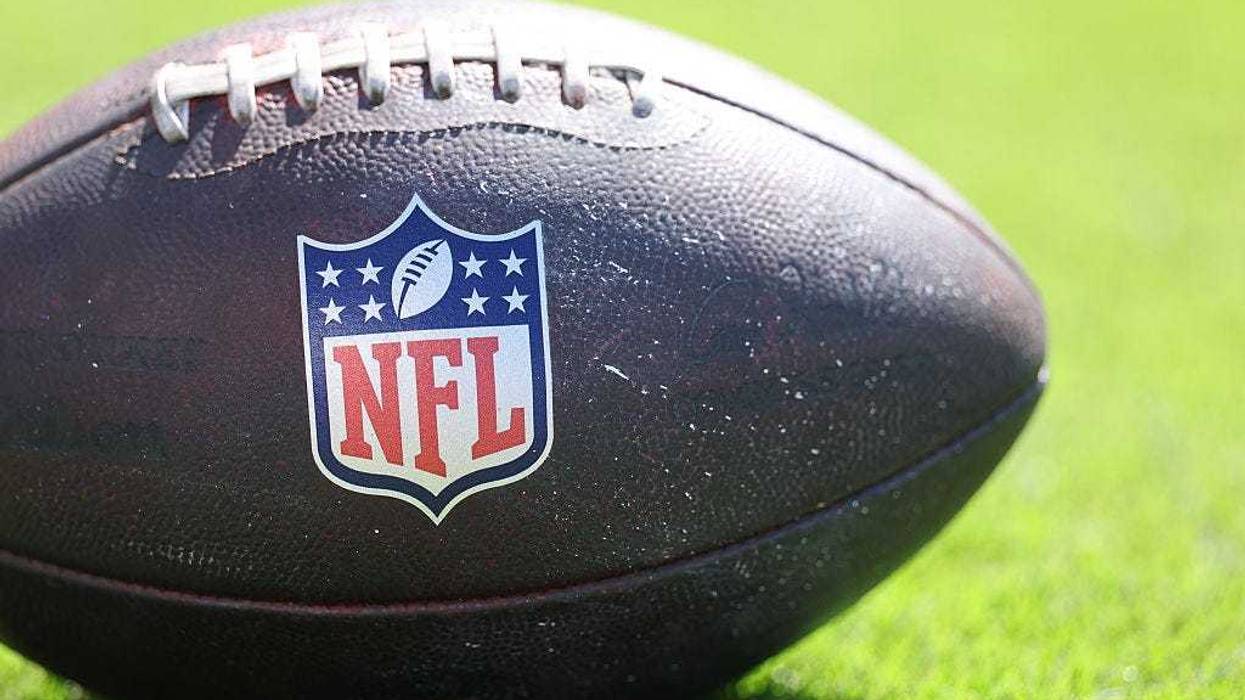 A detailed view of a NFL football is seen with the NFL logo during the NFL 2025 game