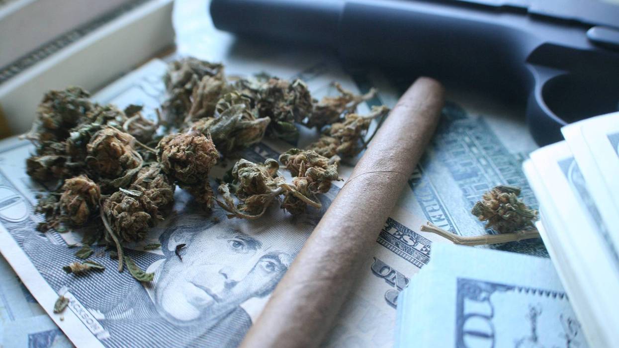 A Detroit man making big money off a vending machine that dispensed marijuana and prescription pills off the side of his house found himself in deeper trouble after police discovered 18 firearms stashed throughout his home.