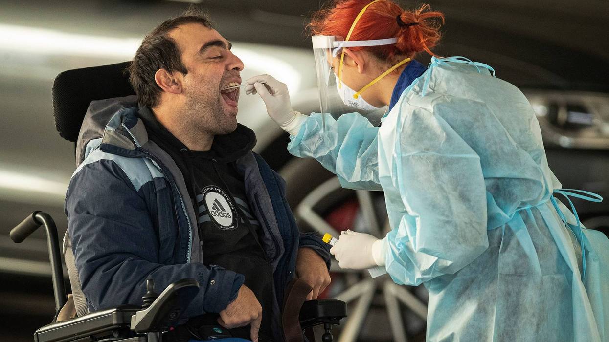 A disabled man is given a COVID-19 test at a drive-in pop-up site in Broadmeadows on July 01, 2020 in Melbourne, Australia.