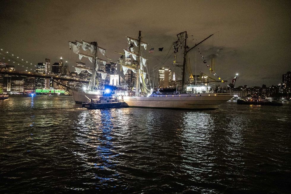 A disabled Mexican Navy tall ship floats between the Brooklyn and the Manhattan bridges on the East River on May 17, 2025